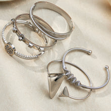 Silver 18k gold plated geometric open bangle set, stacked on light background