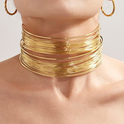 Closeup of 18k gold plated hand-wrapped brushed collar necklace on neck