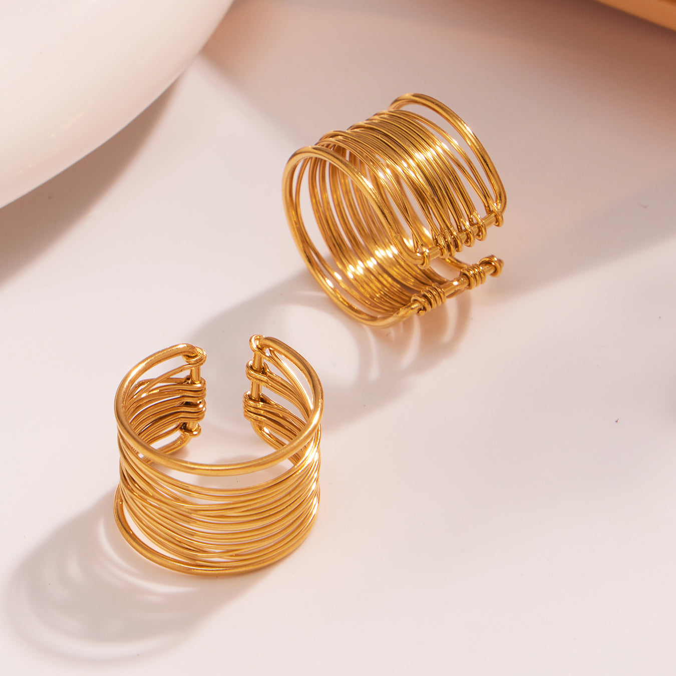 Closeup of 18k gold plated hand-wrapped brushed ring: open adjustable design