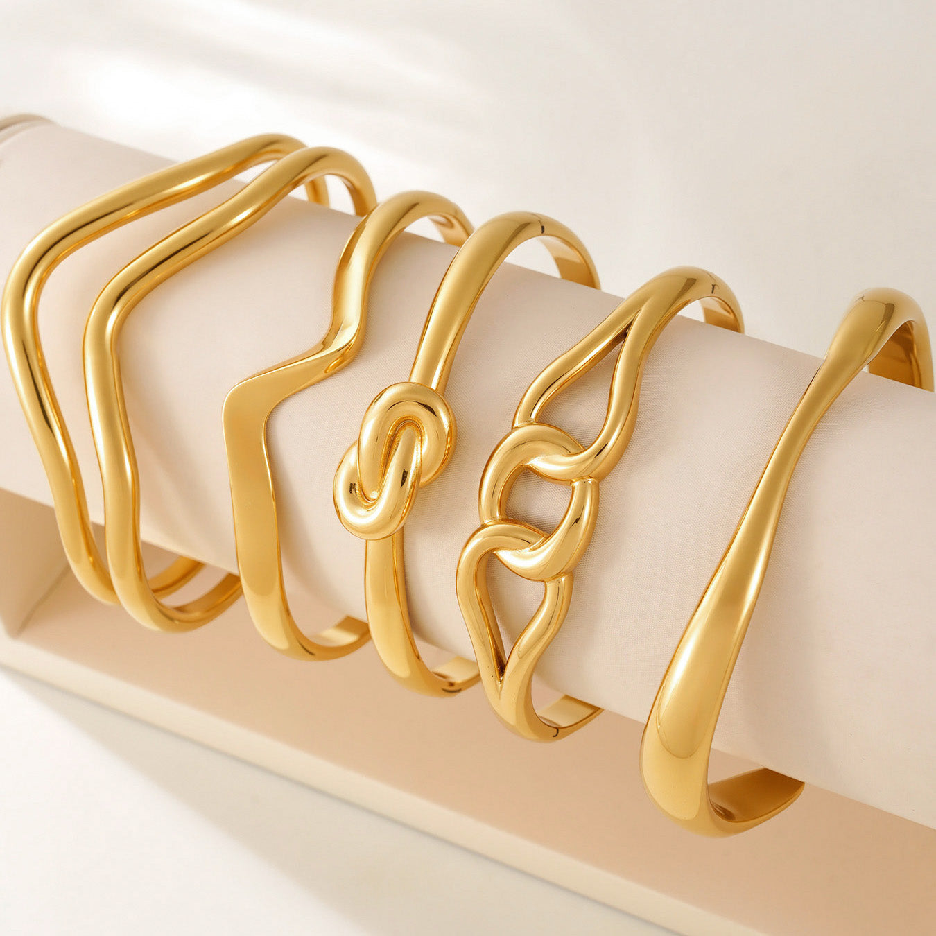 18k gold plated knot twist bangle set collection, gold cuff bracelet display