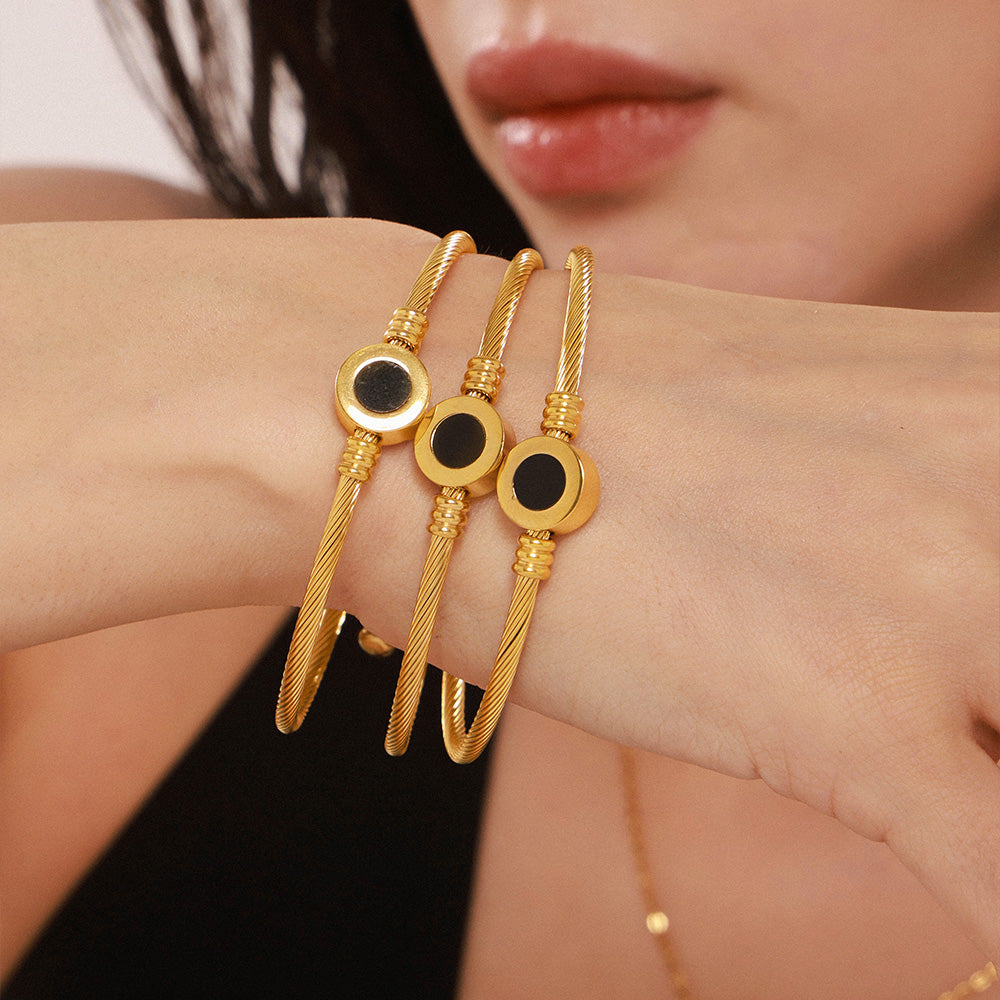 Closeup of 18k gold plated open bangle on wrist: stylish daily-wear accessory