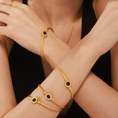 Model wearing 18k gold plated open bangle set: stackable trendy personalize bracelet