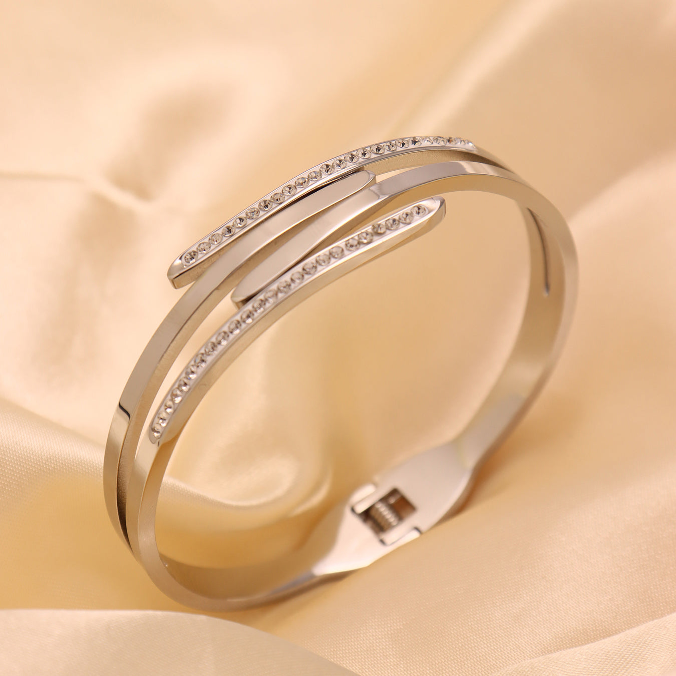 Silver 18k gold plated polished multi-layer rhinestone bangle displayed on satin: elegant office accessory