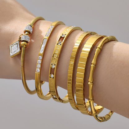 Women wearing 18k gold plated zircon bangle set, gold roman numeral bamboo bracelet