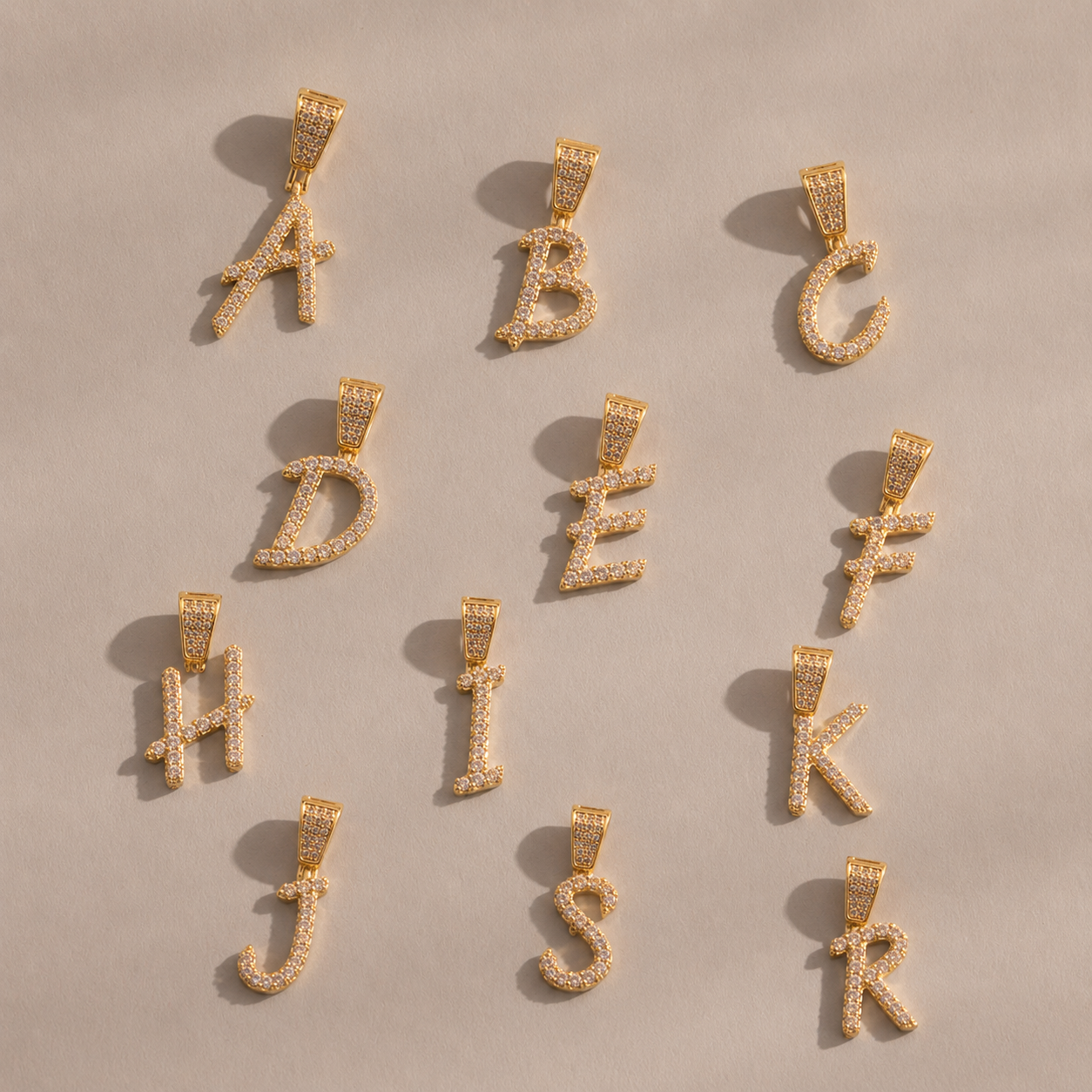 18K gold plated zircon LOVE letter pendant charms displayed on hand, sparkling initial jewelry charms for personalized necklaces