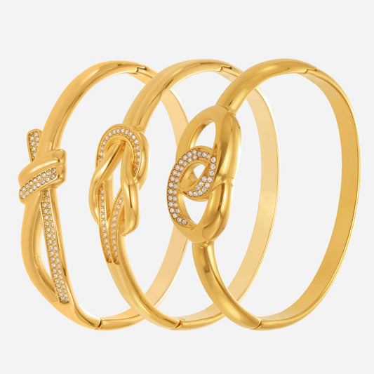 Close-up of 18K gold plated stainless steel bangle set with zircon knot clasp
