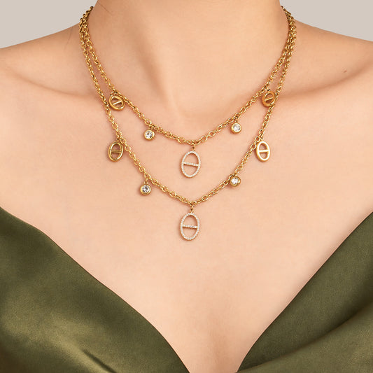 18K gold PVD zircon charm necklace styled in a layered look