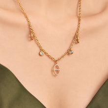 18K gold PVD geometric charm necklace worn on model