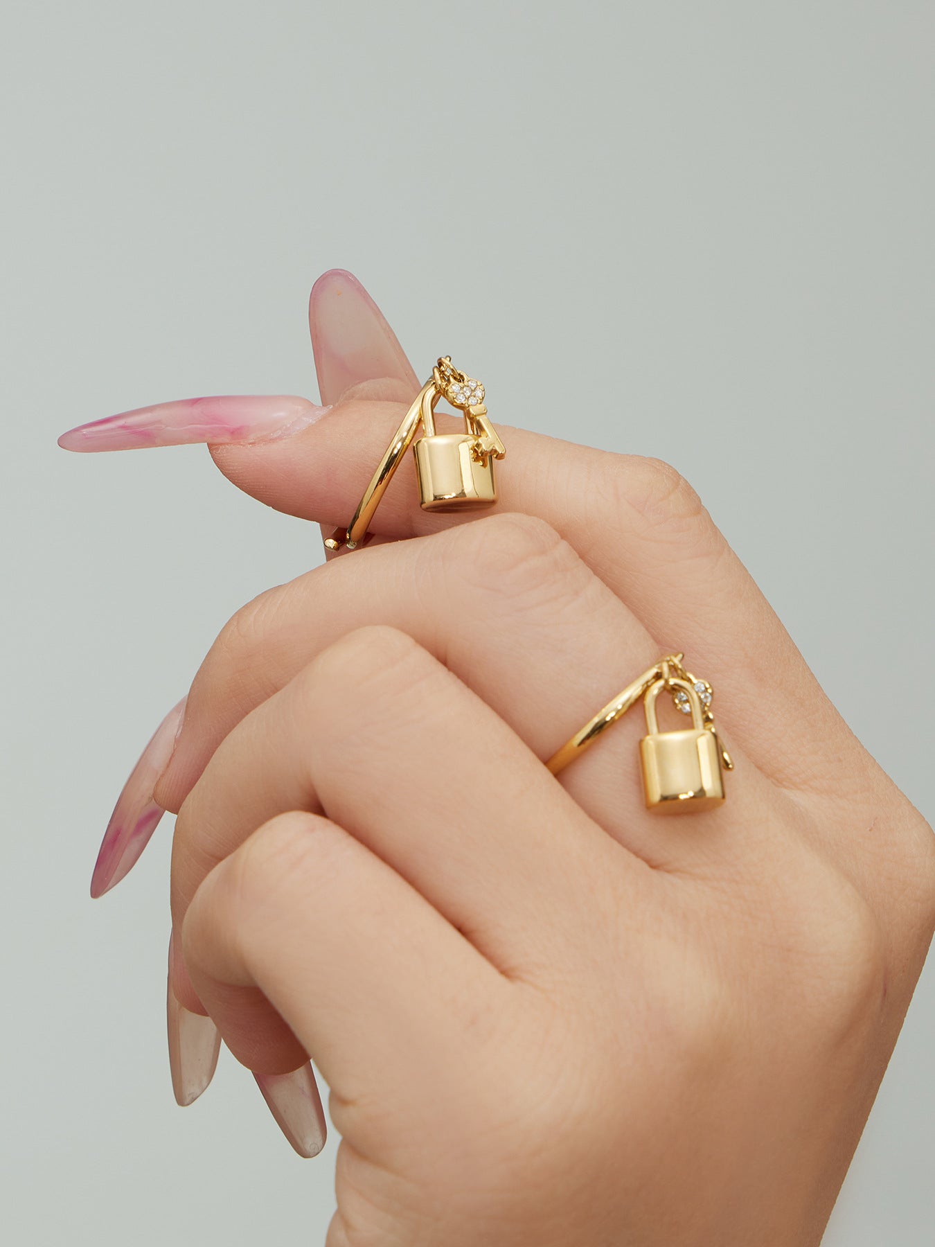 Silver stainless steel lock and key stacked ring with 5A zircon pave worn on finger
