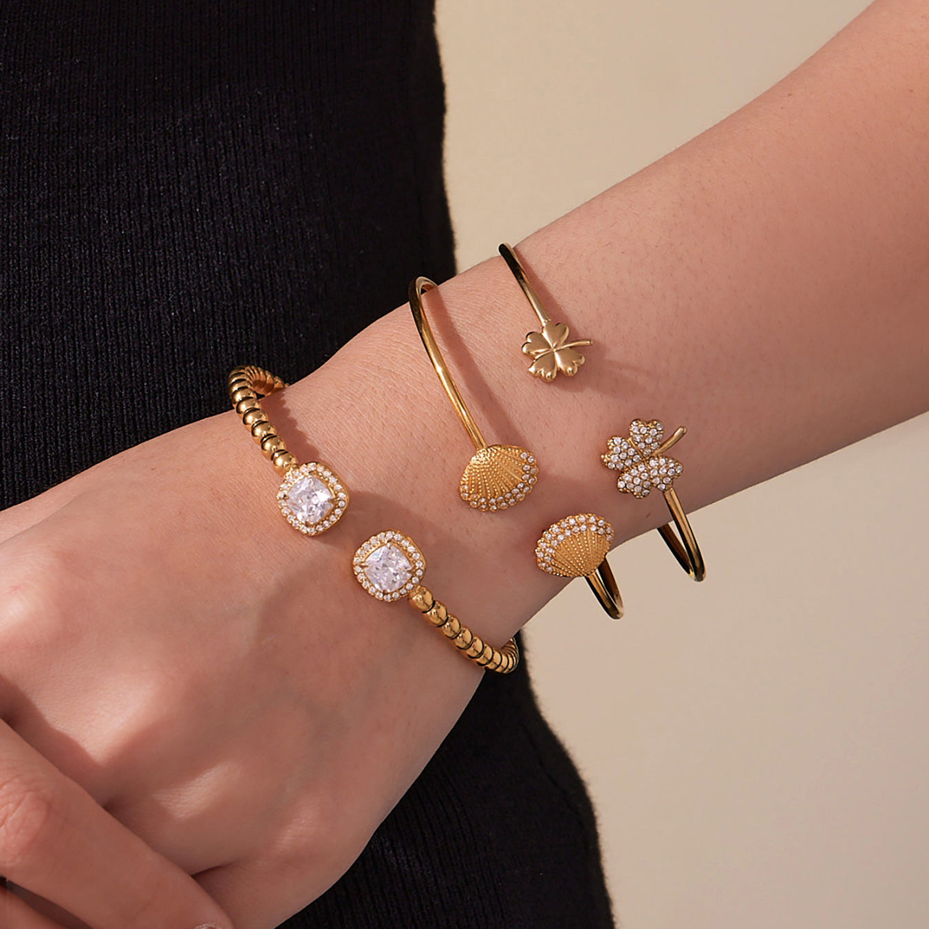 model wearing 18k gold shell clover stone cuff bracelets, side view, chic office wear accessory