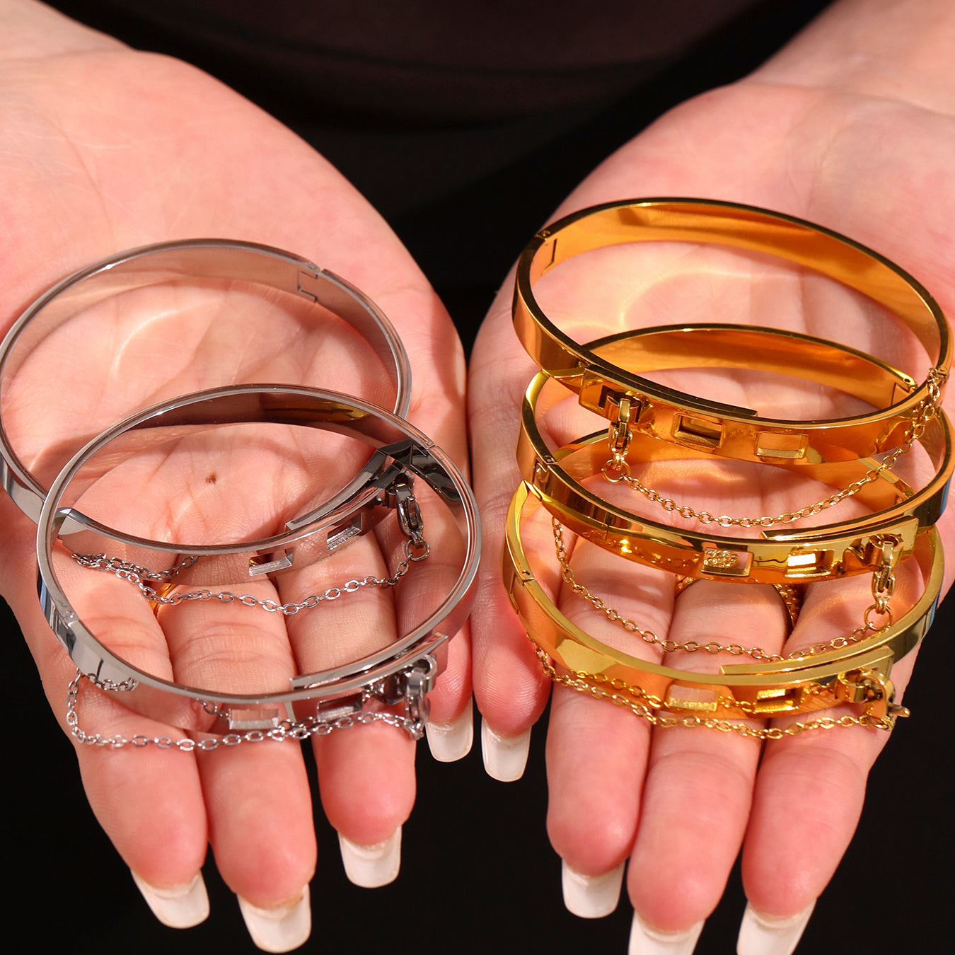 Hands holding 18K gold & silver stainless steel chain clasp bracelet set, wholesale jewelry