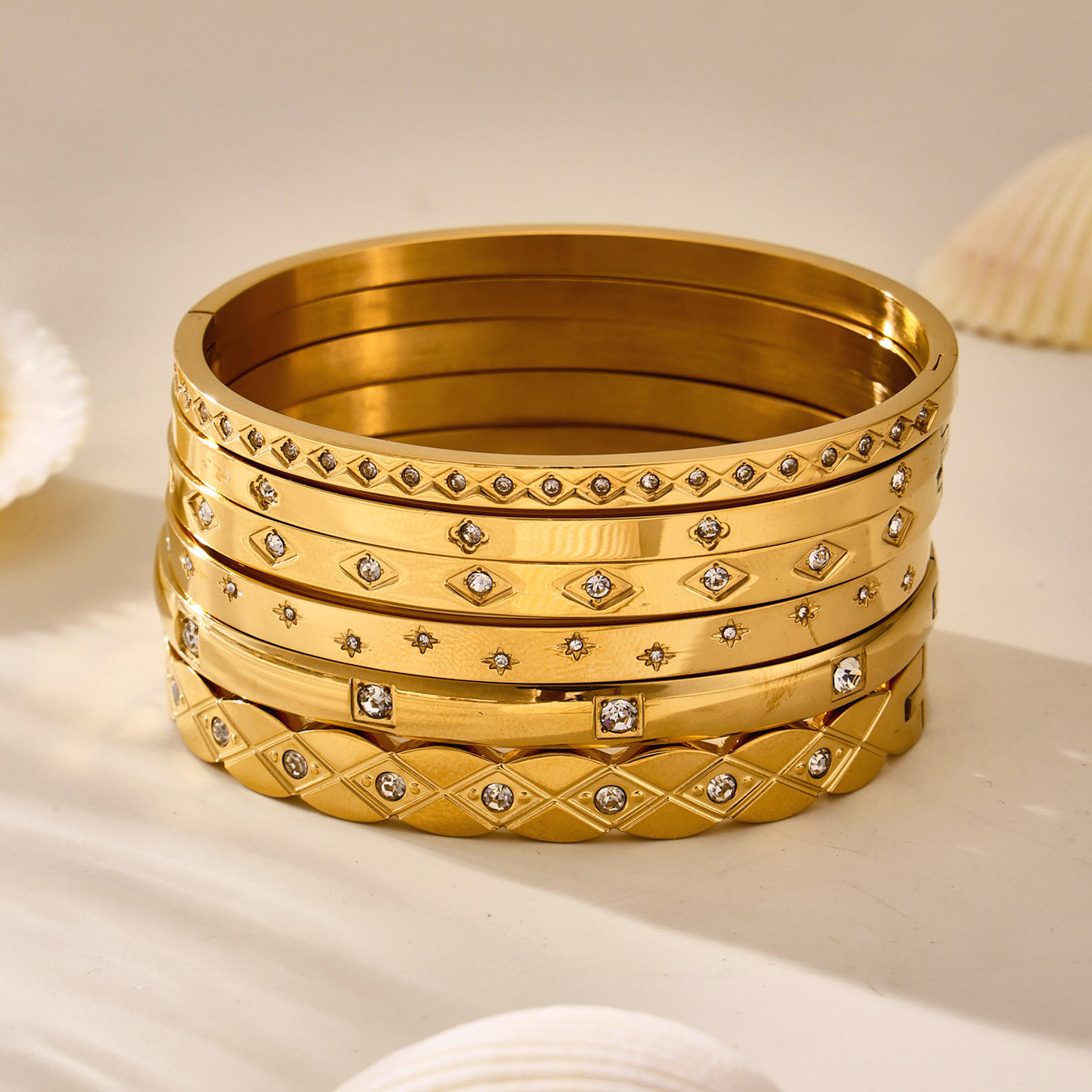 18k gold plated titanium steel zircon bangle set displayed with seashells, european fashion style