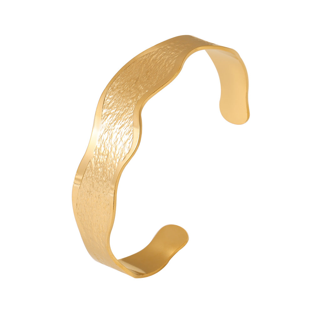 18K gold plated wave texture open bangle on white background, sleek minimalist design