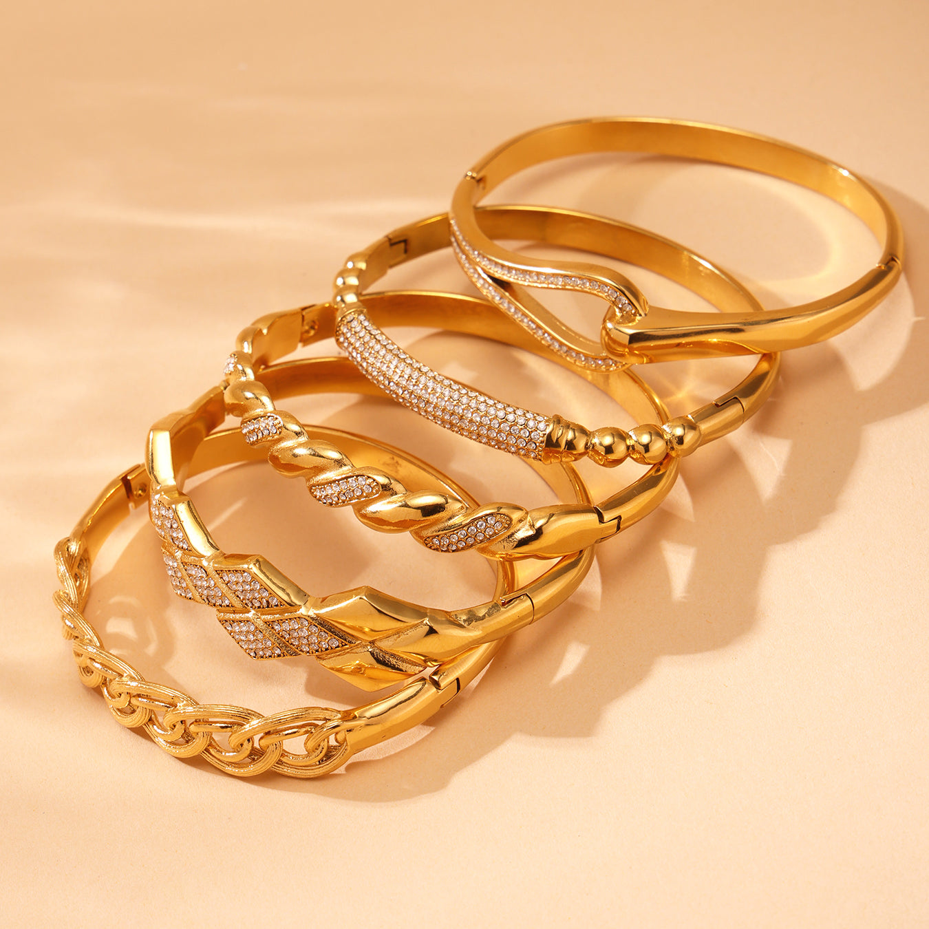 Stacked 18K gold plated zircon bangles displayed on beige background, INS style luxury accessory