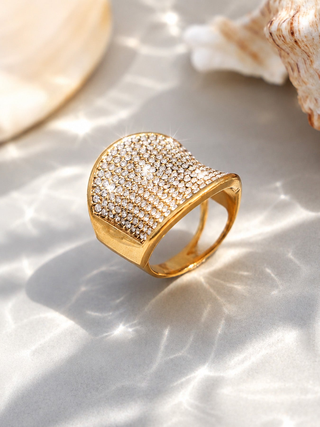 18K PVD gold CZ wide band statement ring on shell background for resort and boutique jewelry displays