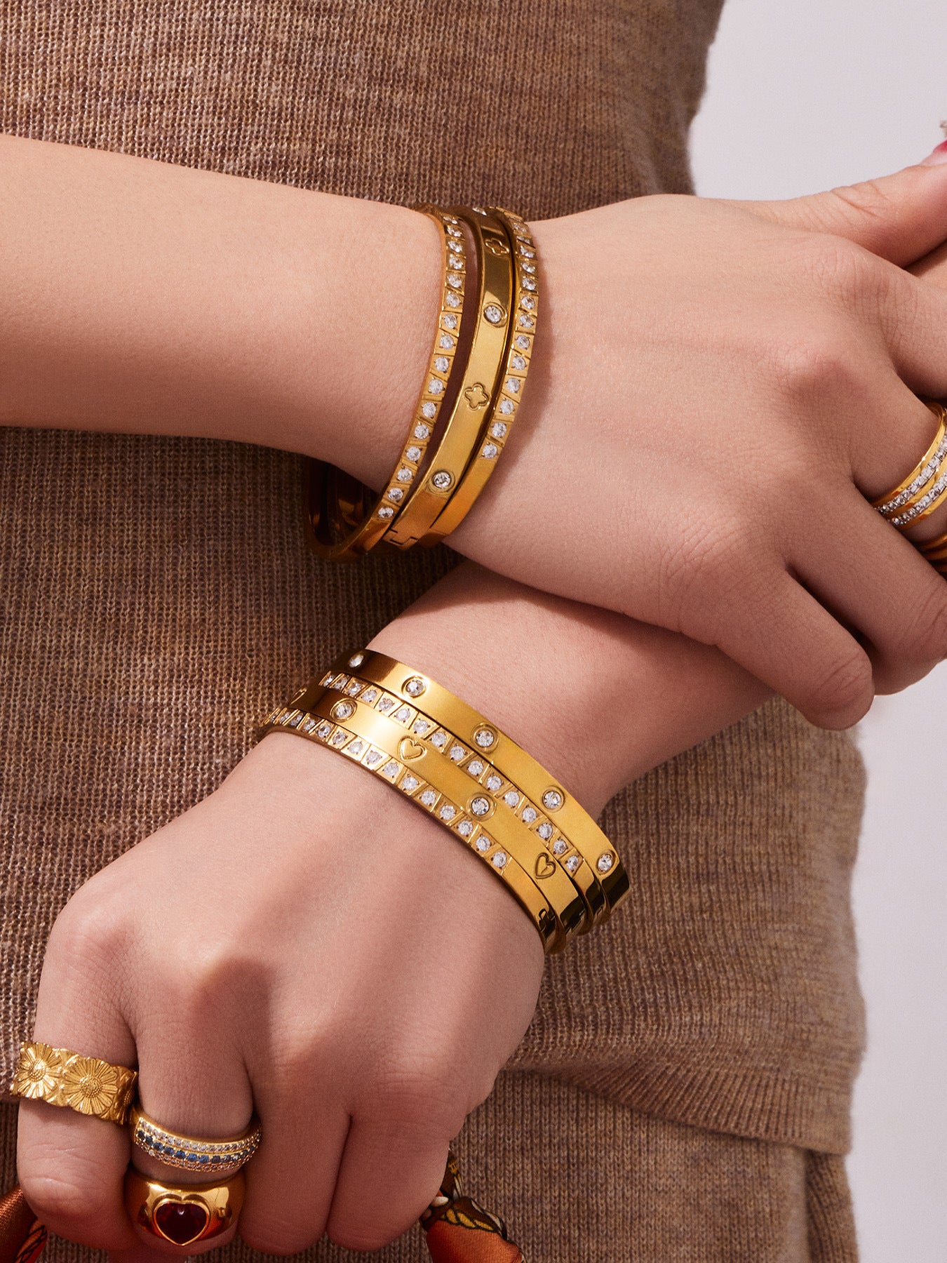 18K PVD gold minimalist bangle worn on the wrist with a neutral outfit