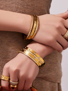 18K PVD gold minimalist bangle worn on the wrist with a neutral outfit