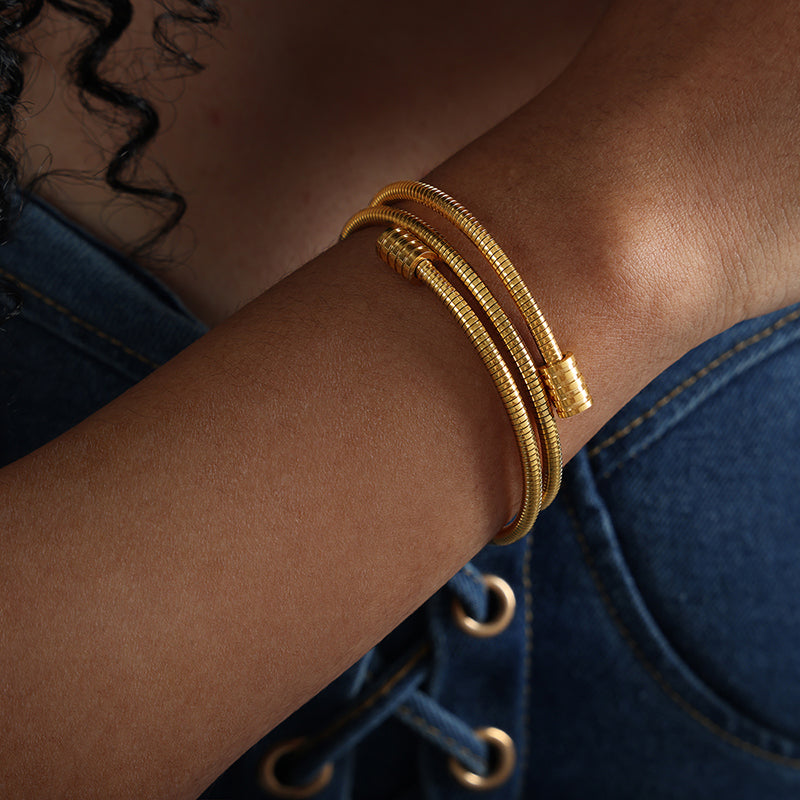 model wearing 18k gold plated titanium steel snake bone chain bracelet, stacked design, fashion casual style