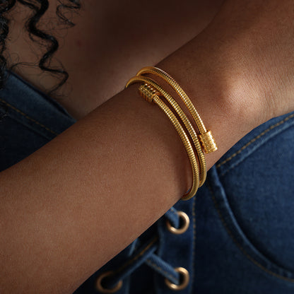 model wearing 18k gold plated titanium steel snake bone chain bracelet, stacked design, fashion casual style