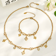 18K PVD gold teardrop zircon necklace and matching bracelet displayed together