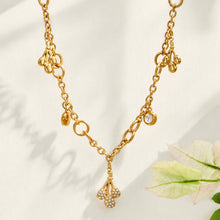 18K PVD gold teardrop zircon necklace displayed on a light fabric background