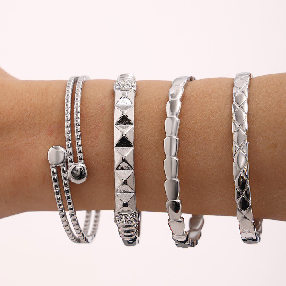 Silver stainless steel luxury bangle set on wrist, trendy minimalist fashion jewelry