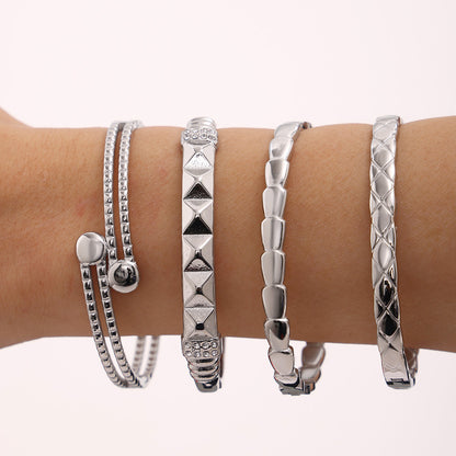 Silver stainless steel luxury bangle set on wrist, trendy minimalist fashion jewelry