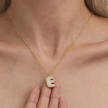 Model wearing gold initial letter necklace by Miduoduo Jewelry for personalized everyday jewelry styling