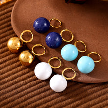 Gold-tone hoop earrings with gold, navy, light blue and white ball drops