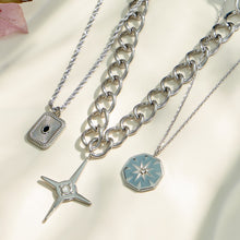 Close-up of square, starburst and four-point cross pendant necklaces with different chain styles