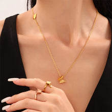 Close up of a model's hand wearing an adjustable 18K gold plated butterfly ring, part of our tarnish resistant jewelry collection for women.