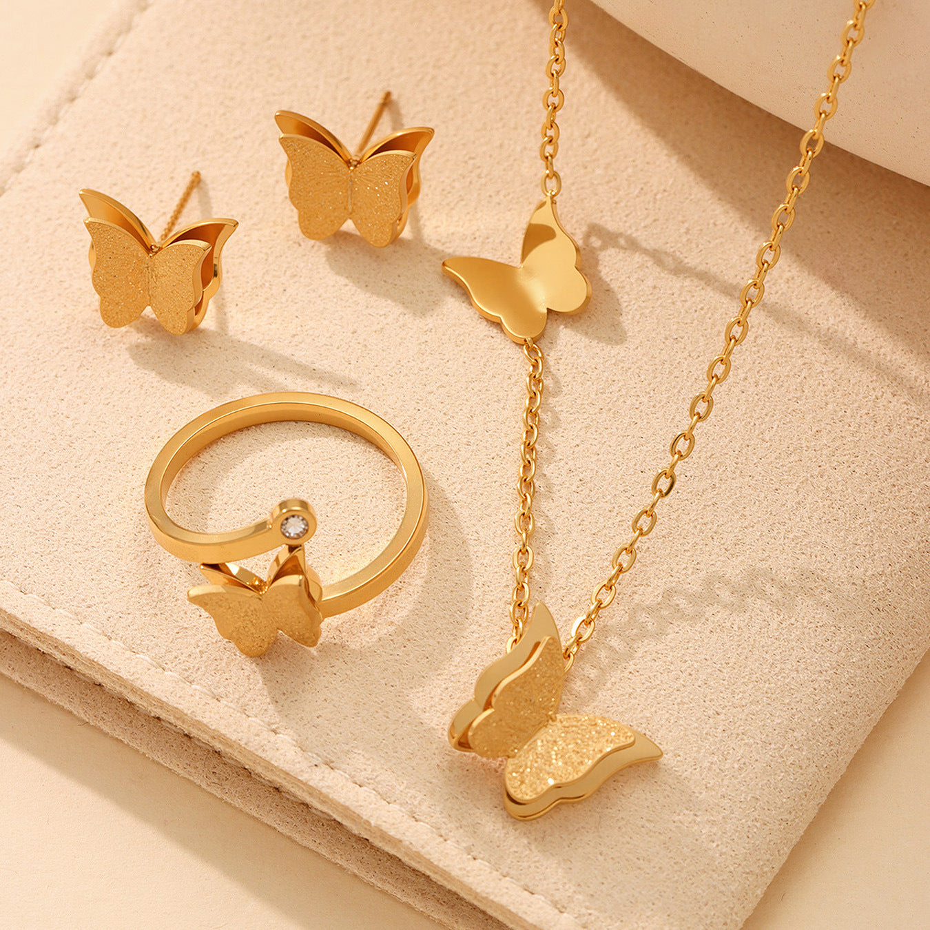 High quality 18K PVD gold plated butterfly jewelry pieces including necklace and earrings, highlighting the intricate 3D design and mirror-polished finish.