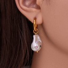 Close up of model wearing elegant waterproof 18K gold plated baroque pearl dangle earrings for sensitive skin.