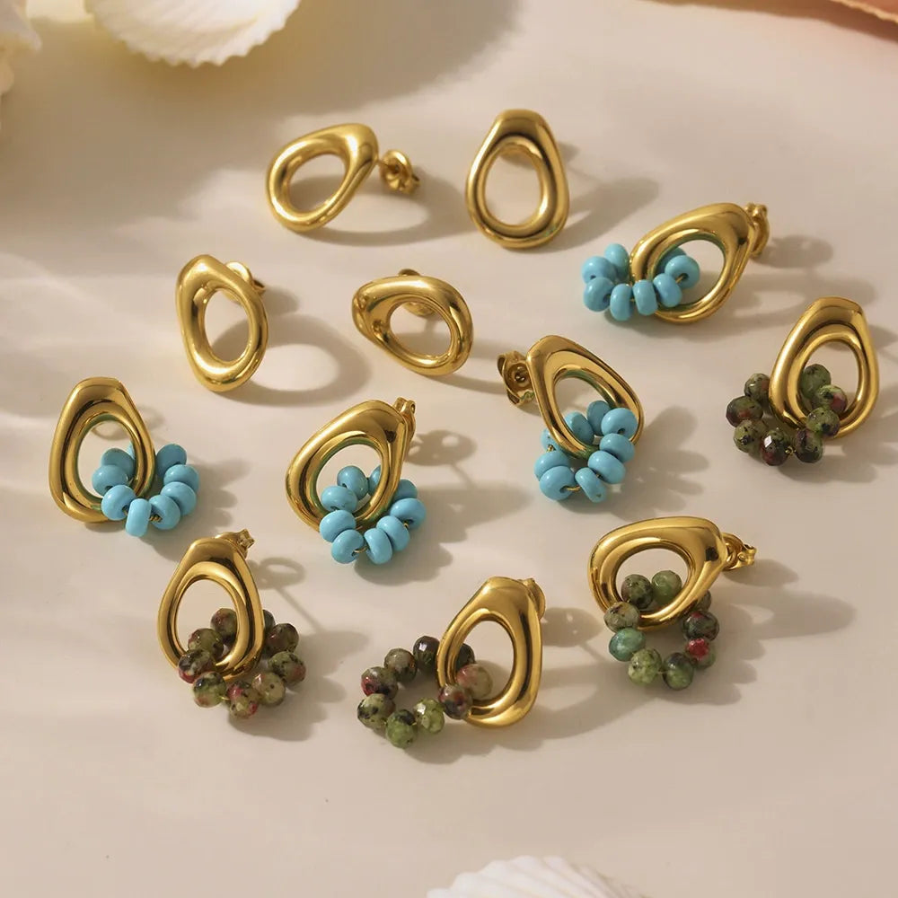 Collection of bulk wholesale hypoallergenic jewelry featuring 18K gold stainless steel turquoise hoop earrings.