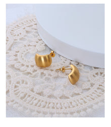 Flat lay of tarnish-free vintage 18K gold plated stainless steel hoop earrings for jewelry wholesale.