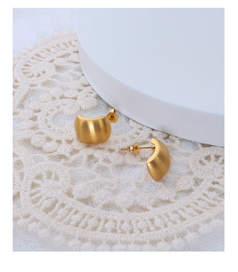 Flat lay of tarnish-free vintage 18K gold plated stainless steel hoop earrings for jewelry wholesale.