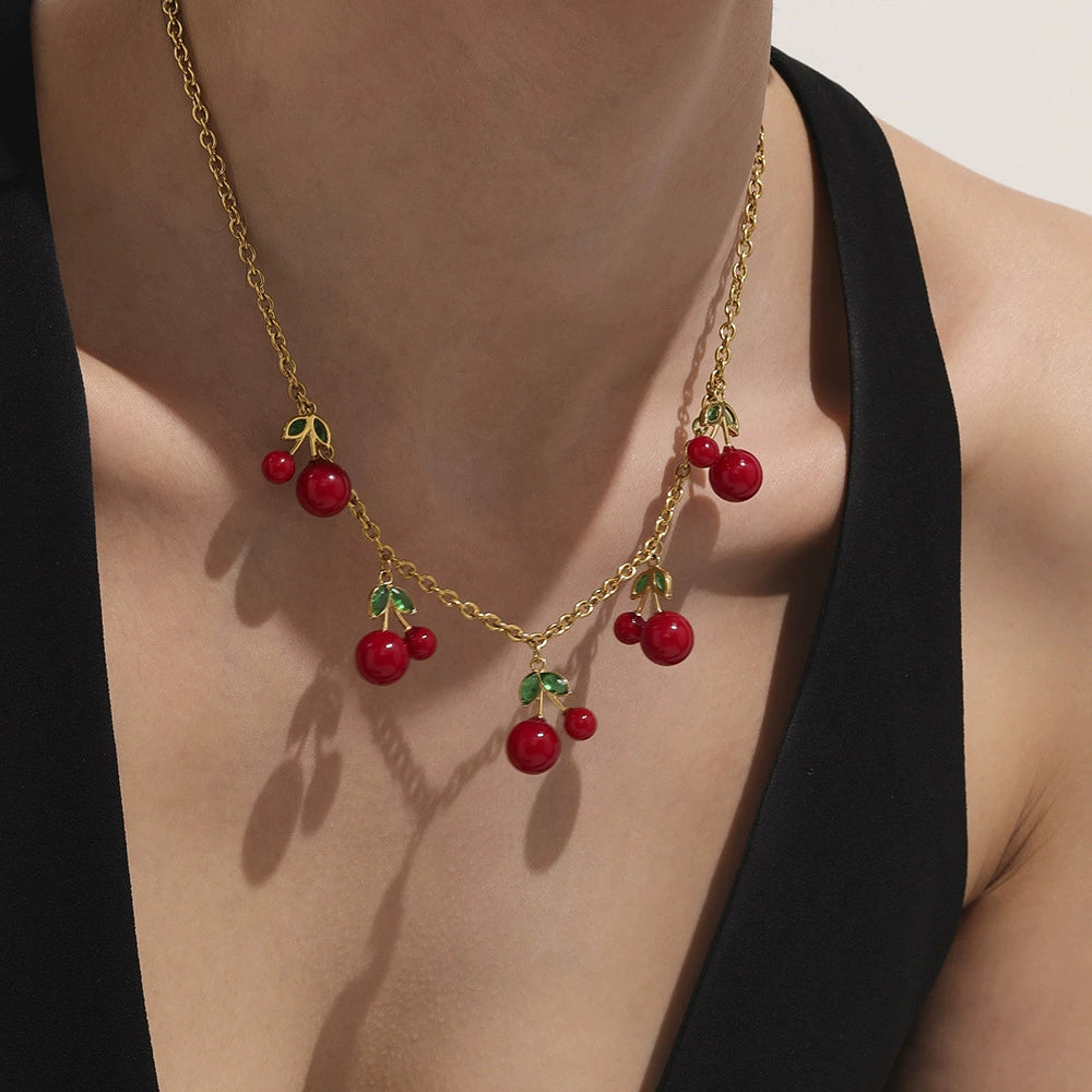 Close up of the dainty cherry charm necklace made of tarnish-free 316L stainless steel, perfect for a whimsical everyday look.