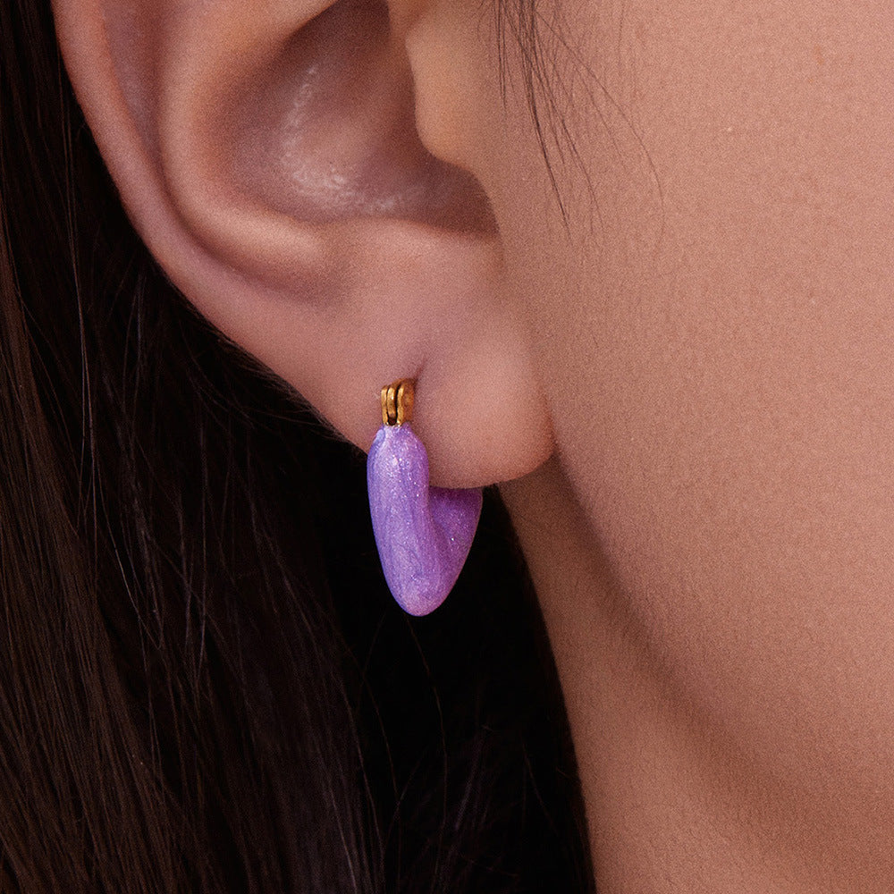 Side profile showing 18K gold plated purple enamel heart drop earrings for everyday wear.