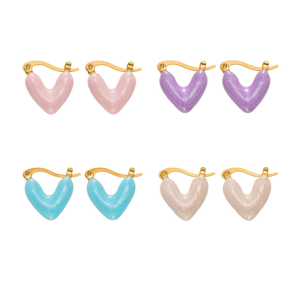 Wholesale colorful enamel heart hypoallergenic huggie earrings in pastel pink, purple, blue, and white.