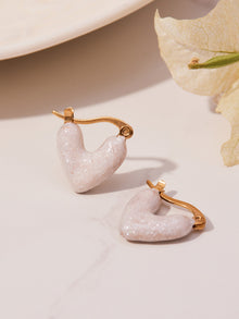Minimalist white enamel heart dangling earrings for a chic and subtle pop of color.