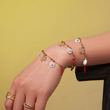 Close up of a model wearing the enamel flower and clover bracelet, showcasing its elegant design on sensitive skin.