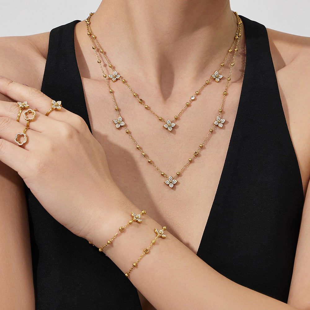 A model wearing the hypoallergenic flower zircon necklace and matching bracelet for a layered jewelry look.