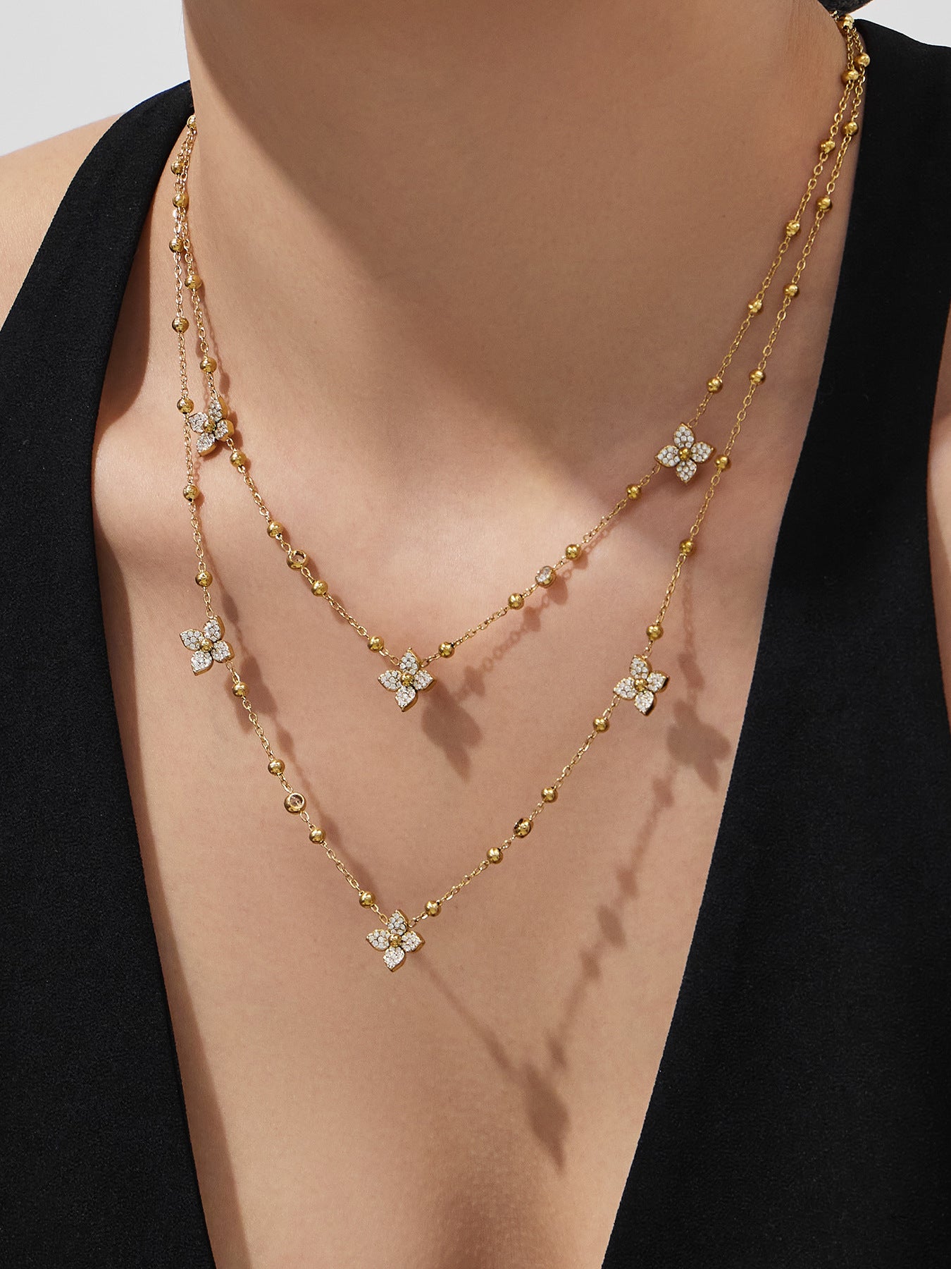 Elegant jewelry set for sensitive skin shown on a model including a flower zircon pendant and stud earrings.