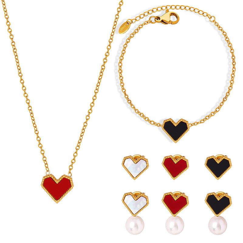 A 316L stainless steel French heart jewelry set featuring gold necklaces, bracelets, and pearl earrings with various colorful inlays.