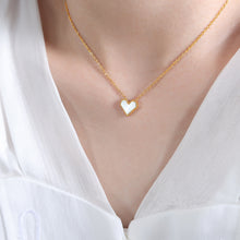 Gold French heart necklace featuring a tiny red inlay, showcasing its tarnish-resistant 18K PVD coating.