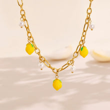The 18K gold plated lemon and pearl necklace displayed in sunlight to highlight its tarnish-resistant and waterproof finish.