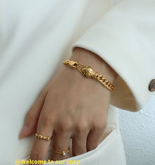 316L Stainless Steel snake head bracelet on model, 18K gold PVD finish, edgy minimalist style
