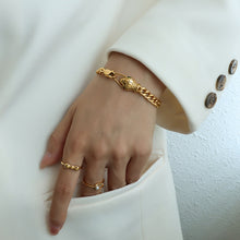 316L Stainless Steel snake head bracelet wrist close-up, black zircon eyes, hypoallergenic