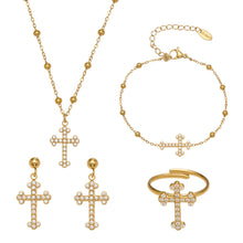 A complete 316L stainless steel cross jewelry set featuring a gold pendant necklace, matching zirconia bracelet, stud earrings, and an adjustable ring.