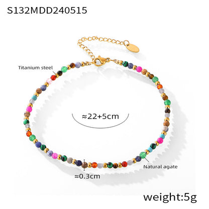 Soft focus flat lay of mixed-color natural stone beaded anklet, adjustable clasp and gold extender for wholesale product photography
